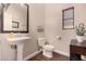 Powder room with pedestal sink, toilet, and dark wood vanity at 581 W Reeves Ave, San Tan Valley, AZ 85140