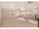 Spacious bonus room with large windows and ceiling fan at 581 W Reeves Ave, San Tan Valley, AZ 85140