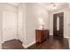 Entryway with wood floors, built-in shelving, and a half bathroom at 581 W Reeves Ave, San Tan Valley, AZ 85140