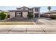 Two-story house with a large driveway and landscaped front yard at 581 W Reeves Ave, San Tan Valley, AZ 85140