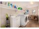 Laundry room with washer, dryer, and storage shelves at 581 W Reeves Ave, San Tan Valley, AZ 85140