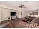 Living area with sectional sofa, TV, and hardwood floors at 581 W Reeves Ave, San Tan Valley, AZ 85140