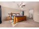 Main bedroom with king bed, ensuite bathroom access, and ceiling fan at 581 W Reeves Ave, San Tan Valley, AZ 85140