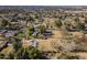 An aerial shot showing a house on a large lot with a pool and distant city views at 616 E Country S Plz, Gilbert, AZ 85234