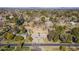 Aerial view showing a house on a large lot with surrounding trees and distant city views at 616 E Country S Plz, Gilbert, AZ 85234