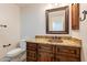 Bathroom boasts granite countertop, copper sink, and wood cabinets at 616 E Country S Plz, Gilbert, AZ 85234