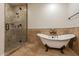 Bathroom with walk-in shower and clawfoot tub at 616 E Country S Plz, Gilbert, AZ 85234