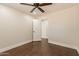 Light and airy bedroom with wood floors, ceiling fan and access to hallway at 616 E Country S Plz, Gilbert, AZ 85234