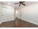 Bedroom with wood floors, ceiling fan and double door closet at 616 E Country S Plz, Gilbert, AZ 85234