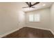 Well-lit bedroom featuring wood floors, plantation shutters and ceiling fan at 616 E Country S Plz, Gilbert, AZ 85234