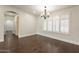 Formal dining room with hardwood floors and a chandelier at 616 E Country S Plz, Gilbert, AZ 85234