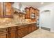 Kitchen with granite countertops and wood cabinets at 616 E Country S Plz, Gilbert, AZ 85234