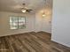 Bright living room with wood-look floors, large window, and ceiling fan at 620 S Laveen Dr, Chandler, AZ 85226