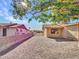 Gravel backyard with a view of neighboring houses and a partial view of the house at 6554 E Dallas St, Mesa, AZ 85205