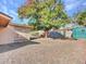 Backyard view with a large tree and a green shed at 6554 E Dallas St, Mesa, AZ 85205