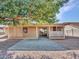 Home's backyard features a large patio and mature shade tree at 6554 E Dallas St, Mesa, AZ 85205