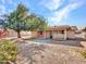 Backyard view of home with patio and mature tree at 6554 E Dallas St, Mesa, AZ 85205