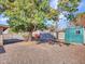 Large backyard with gravel and a green storage shed at 6554 E Dallas St, Mesa, AZ 85205