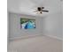 Well-lit bedroom with neutral walls, carpeting, and ceiling fan at 6554 E Dallas St, Mesa, AZ 85205