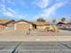 Single-story home with a two-car garage and desert landscaping at 6554 E Dallas St, Mesa, AZ 85205