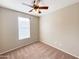 Spacious bedroom with ceiling fan and large window at 6710 E University Dr # 147, Mesa, AZ 85205