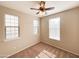 Well-lit bedroom with ceiling fan and two windows at 6710 E University Dr # 147, Mesa, AZ 85205