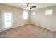 Bright bedroom with carpeted floor, ceiling fan, and private balcony access at 6710 E University Dr # 147, Mesa, AZ 85205