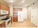 Galley kitchen with wood cabinets and white appliances at 6710 E University Dr # 147, Mesa, AZ 85205