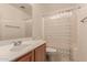 Bathroom with single vanity, shower/tub combo, and floral curtain at 7304 E Northridge Cir, Mesa, AZ 85207