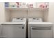 Bright laundry room with washer and dryer, and shelving at 7304 E Northridge Cir, Mesa, AZ 85207