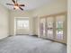 Comfortable bedroom with carpeted floor, large window and door leading outside at 8494 E Gilded Perch Dr, Scottsdale, AZ 85255