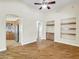 Gathering room with hardwood floors, built-in shelving, and a ceiling fan at 8494 E Gilded Perch Dr, Scottsdale, AZ 85255