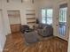 Cozy living room with a gray sofa and chairs, built-in shelves, and natural light at 8494 E Gilded Perch Dr, Scottsdale, AZ 85255