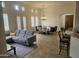 Open concept living room featuring a gray sectional sofa and a dining area with a chandelier at 8494 E Gilded Perch Dr, Scottsdale, AZ 85255