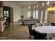 Open concept living room with gray sectional sofa and dining area with chandelier at 8494 E Gilded Perch Dr, Scottsdale, AZ 85255