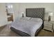 Elegant main bedroom with a gray tufted headboard and ensuite bathroom at 8494 E Gilded Perch Dr, Scottsdale, AZ 85255