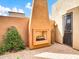 Outdoor patio with a built-in fireplace and seating area at 8494 E Gilded Perch Dr, Scottsdale, AZ 85255