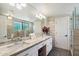 Elegant bathroom with double sinks, marble counters, and a walk-in shower at 8608 E Palo Verde Dr, Scottsdale, AZ 85250