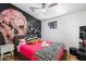 Stylish bedroom with pink bedding, skull wall art, and hardwood floors at 8608 E Palo Verde Dr, Scottsdale, AZ 85250