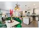 Open concept dining area with green chairs and a view into the living area at 8608 E Palo Verde Dr, Scottsdale, AZ 85250