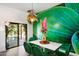 Charming dining area with green chairs and a view of the pool through glass doors at 8608 E Palo Verde Dr, Scottsdale, AZ 85250