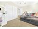 Bedroom with a daybed, built-in closet, and ceiling fan at 8709 W Hammond Ln, Tolleson, AZ 85353