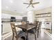 Bright dining room adjacent to kitchen, featuring a wooden table and chairs at 8709 W Hammond Ln, Tolleson, AZ 85353