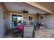 Covered patio with seating area, ceiling fans, and access to backyard at 9215 W Raintree Dr, Sun City, AZ 85351