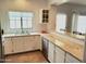 Well-equipped kitchen featuring white cabinetry, granite counters, and a large sink at 9253 N Firebrick Dr # 212, Fountain Hills, AZ 85268