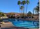 Inviting community pool with lounge chairs and palm trees at 9253 N Firebrick Dr # 212, Fountain Hills, AZ 85268