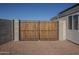 Wooden gate with black metal frame in backyard at 9321 W Hillcrest Pl, Arizona City, AZ 85123