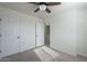 Bright bedroom with ceiling fan and access to laundry at 9321 W Hillcrest Pl, Arizona City, AZ 85123