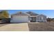 Single-story home with a two-car garage and desert landscaping at 9321 W Hillcrest Pl, Arizona City, AZ 85123