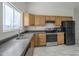 Modern kitchen featuring wood cabinets and stainless steel appliances at 9321 W Hillcrest Pl, Arizona City, AZ 85123